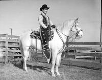 Bob Wills [on horseback in a corral]