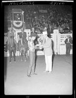 Guy Weeks and Gov. Love (buckle) in arena