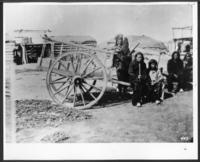 Indians-Red River Cart, Indian lodge in background