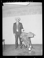 Dean Oliver with Calf Roping saddle and Buckle  (upstairs)