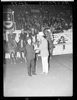 Johnny Hawkins and Gov. Love (buckle) in arena