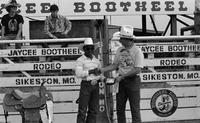 Bull riding award presentation, unknown participants