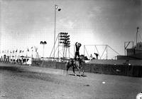 [Unidentified Cowgirl doing Hippodrome stand with one hand on head the other nearly there]