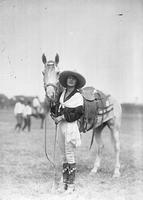 [Mabel Strickland posed beside horse]