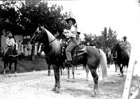 [Unidentified cowgirl contestant wearing "Mara" sash on horse]