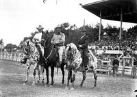 [Leo Cremer between two unidentified men mounted on two Leopard Appaloosas and one Black]