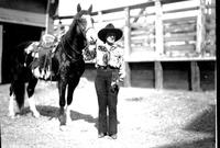 [Possibly Bea Kirnan posing with horse]