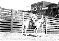 [Mamie Francis' midget assistant sitting atop mule]