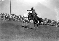 [Paul Garner riding saddle bronc]