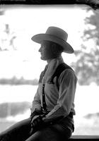 [Unidentified cowboy seated in profile]