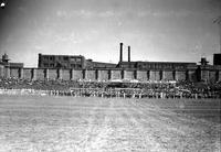 [Large marching band spread across front of chutes at Prison Rodeo]