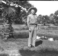 [Possibly Jack Rinehart standing near a palmetto tree]