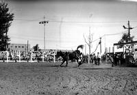 [Unidentified Cowboy leaving head-first off rear of kicking Saddle Bronc]