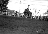 [Unidentified Cowboy riding Saddle Bronc who is completely airborne]