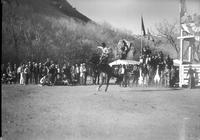 [Unidentified Cowboy riding and staying with rearing bronc]