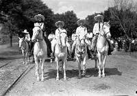 [Possibly Mamie Francis & California Frank between unidentified cowboy and cowgirl on horses]