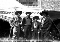 [Col. Eskew, Tris Speaker, Uncle Herbie, & Foghorn Clancy standing in front of awning of tent]