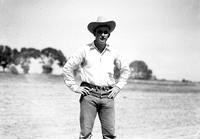 [Unidentified cowboy standing with hands on hips]