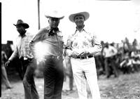 [Autry in flowered shirt standing by possibly Everett Colborn]