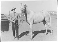 Johnnie Lee Wills posing with a horse