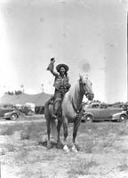 [Unidentified cowgirl in fanciful costume on horse]