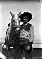 [Unidentified Cowboy in two-toned shirt with horse]