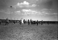 [Group of Indian men dancing in middle of arena]