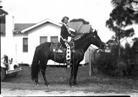 [Unidentified lady trick rider posed atop horse]