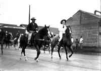 [Unidentified Cowboy and possibly Violet Clements moving down trolley car tracks]