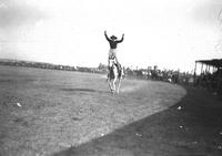 [Unidentified cowgirl doing hippodrome stand]