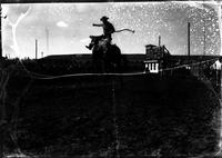 [Unidentified Cowboy and Bronc airborne]