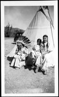 Three Blackfeet children in front of tipi