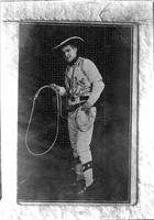 [Unidentified cowboy standing and holding rope]