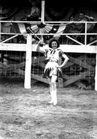 [Unidentified drum majorette posed in front of bandstand]