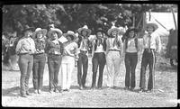 [Group of nine unidentified cowgirls posed in a line]