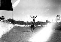 [Unidentified Cowgirl doing hippodrome stand with arms extended into "Y" shape]