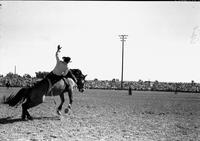 [Unidentified Cowboy on his way off bareback bronc]