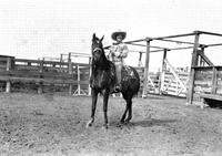 [Mamie Stroud on horse in corral]