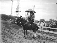 [Unidentified rodeo clown posed atop mule]