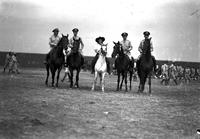 [Possibly Sally Rand on horseback with four uniformed men on horses with English saddles]