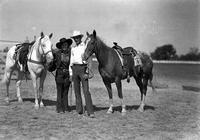 [Vaughn Krieg and Lynn Huskey standing by their horses]