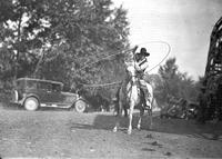 [Unidentified Trick roper on horse twirling large loop]