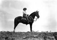 [Unidentified older cowgirl atop horse]
