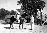 [Possibly Silver Dollar Brady on horseback with unidentified lady in foreground]