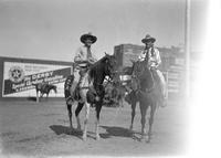 [Two unidentified cowboys on horses one horse has star breast collar, one cowboy has stars on shirt]