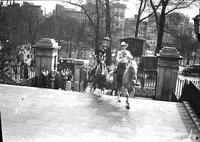 [Unidentified Cowboy & possibly Alice Sisty atop horses coming up outside steps]