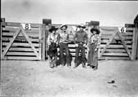 [Possibly Margie Greenough, unidentified cowboy, Turk and Alice Greenough in front of chutes]