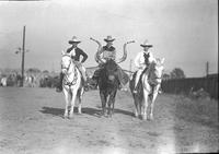 [Monte Reger atop Bobby the steer between perhaps a mounted Frank Hafley & Mamie Francis]