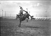 [Unidentified Cowboy riding bronc]