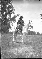 [Possibly Vaughn Krieg posed atop white horse]